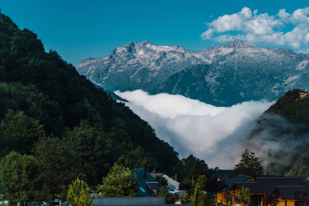 A serene Himalayan landscape in Sikkim with misty mountains, winding valleys, and soft clouds creating a dreamlike atmosphere.