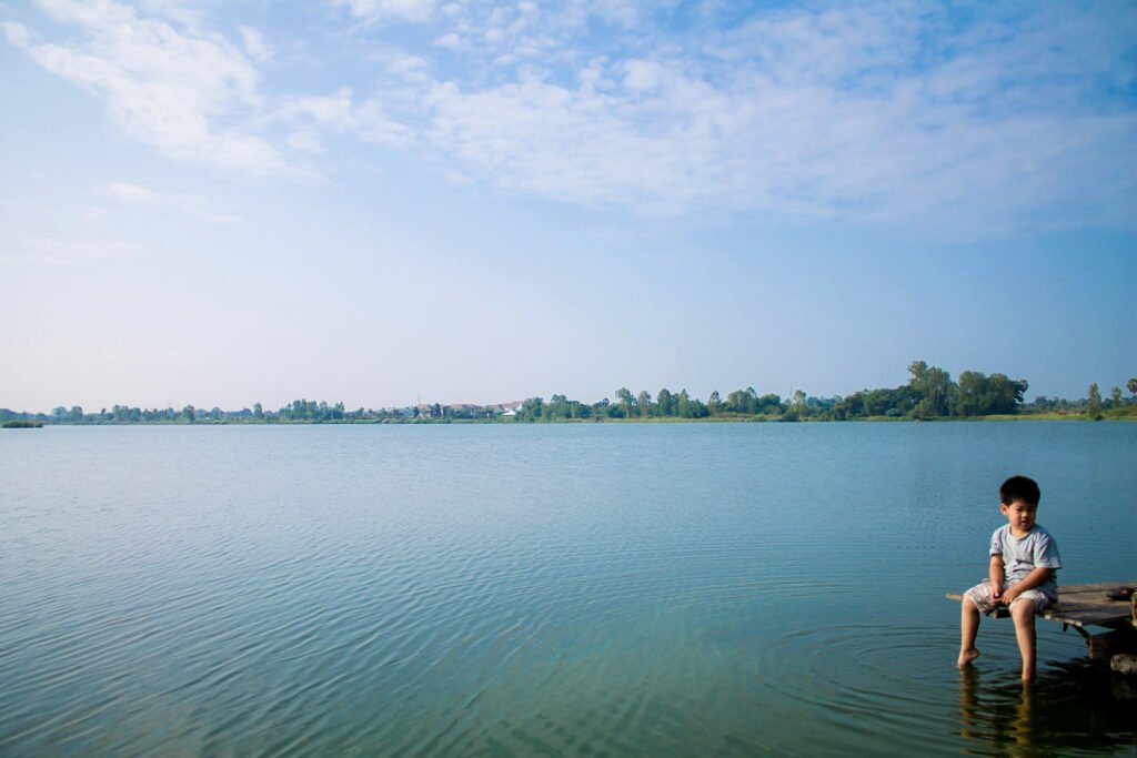 a boy relaxing on water front in a summertime 2025 03 12 21 49 31 utc